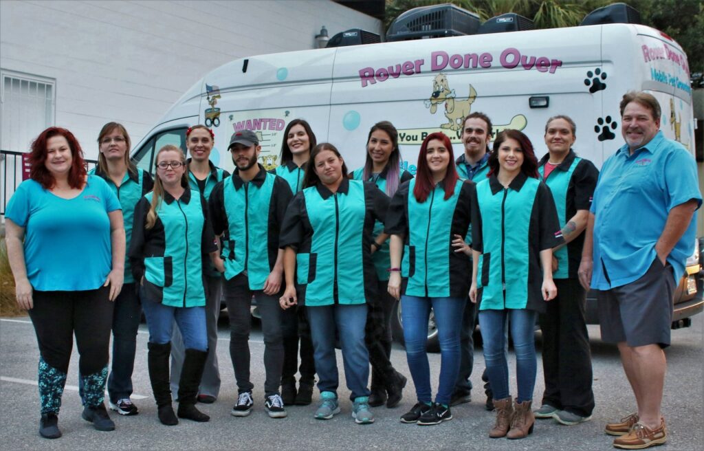 Rover Done Over Team Photo next to owners and Mobile Unit