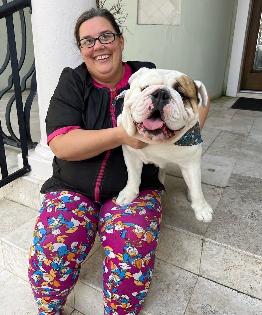 Pet Stylists next to one of our happy client's dog